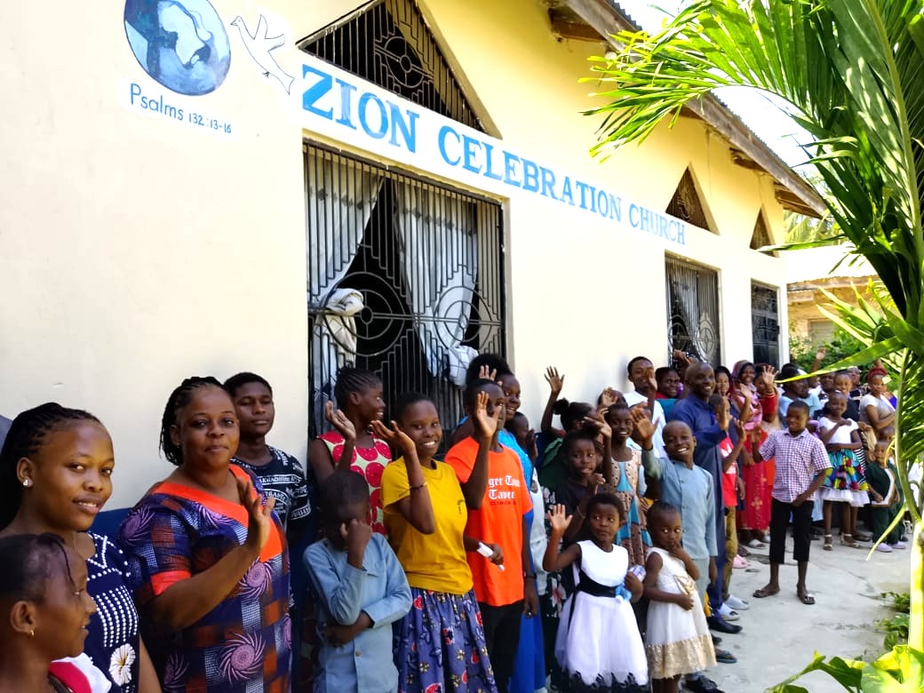 ZCC outside Church Waving